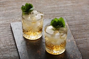 Glass of rum on the wooden background, Cuba Libre or long island iced tea cocktail with strong drinks