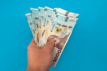 UAH. Money of Ukraine 1000 hryvnia, Ukrainian banknote isolated on blue