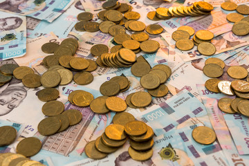 gold coins lie on banknotes. UAH. Ukrainian money