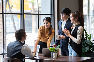 Group of Asian Business People Successful Teamwork in Casual Suit Working Together with Laptop Computer at Co-Working Space