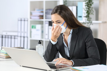 Executive touching protective mask working at office