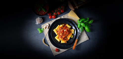 Rigatoni pasta with Bolognese sauce and fresh basil