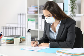 Executive with mask signing contract at office