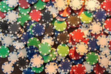 Casino poker chips on green felt background. All for success game