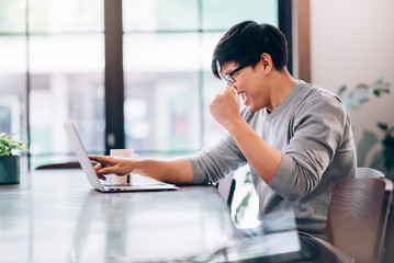Fototapeta premium Handsome Asian Man Using Laptop Computer Connect with High Speed Internet 5G Wireless Connection Technology Work from Home , E-Learning , Online Shopping , E-Commerce , Freelance Concept