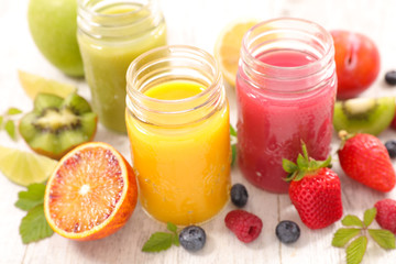 Fototapeta na wymiar fruit juice, orange, berry fruit and kiwi smoothie