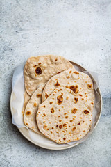 Homemade indian flatbread chapati on a gray background. Vegetarian cuisine concept.