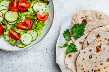 Homemade indian flatbread chapati on a gray background. Vegetarian cuisine concept.