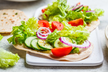 Homemade flatbread with fresh vegetables. Healthy vegan food concept.