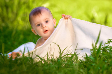 Little boy tried to hide from his parents using the blanket