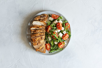 Close-up on a salad with chicken and tomato