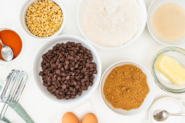 Chocolate chips and ingredients for baking needs close up on a kitchen table. Chocolate Chip Cookies recipe