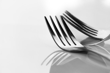 metal fork for food dinner still life reflection on round mirror black and white classic background