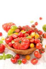 assorted of colorful tomatoes and basil