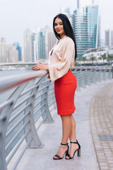Fototapeta na wymiar Portrait of a confident businesswoman on broadwalk in a city