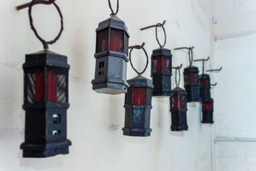 A row of ancient kerosene lanterns on a wall