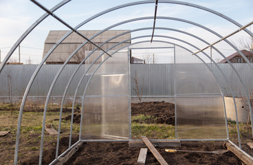 Fototapeta premium Installation of a greenhouse in the garden.