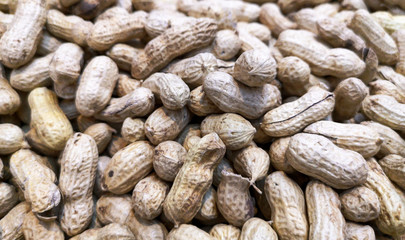 Fototapeta premium Unpeeled peanuts as background
