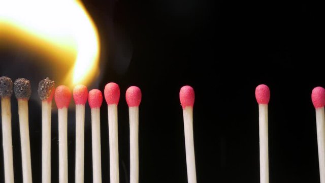 Close Up of wax matches burning on black background. Social Distancing Concept