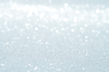 Silver Sparkling Lights Festive background with texture. Abstract Christmas twinkled bright bokeh...