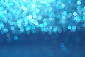 blue Sparkling Lights Festive background with texture. Abstract Christmas twinkled bright bokeh defocused and Falling stars. Winter Card or invitation	