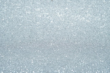 Silver Sparkling Lights Festive background with texture. Abstract Christmas twinkled bright bokeh defocused and Falling stars. Winter Card or invitation	