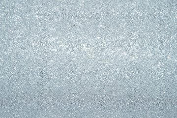 Obraz premium Silver Sparkling Lights Festive background with texture. Abstract Christmas twinkled bright bokeh defocused and Falling stars. Winter Card or invitation 