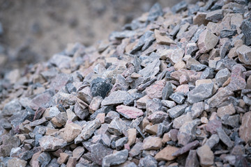 A bulk of gravel rock which is preparation for construction working site, material for building industrial. Close-up and selective focus at the center.