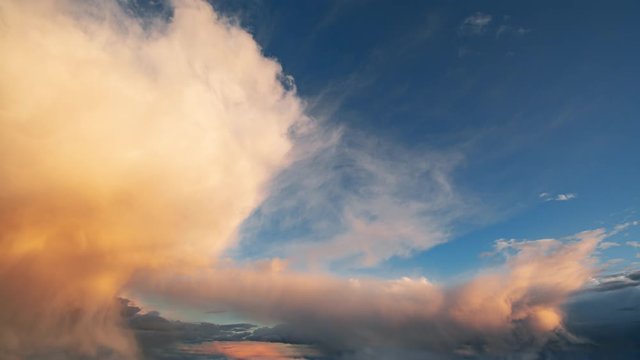 Amazing timelapse of bright sunset clouds moving over the sky. Beautiful orange and yellow colors gradually fading and the sky clearing in the end. 