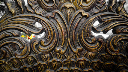 Iron fence ornaments and wooden doors in ancient Roman style buildings.