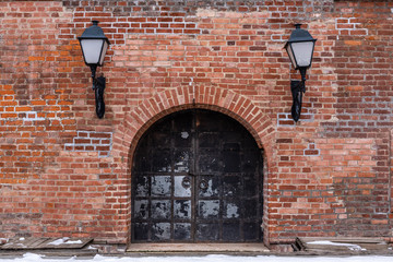 Old metal gate. Brick wall