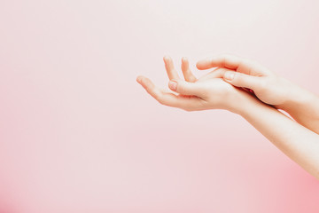 Woman's hand on pink background, concept template feminine blog, social media, beauty concept