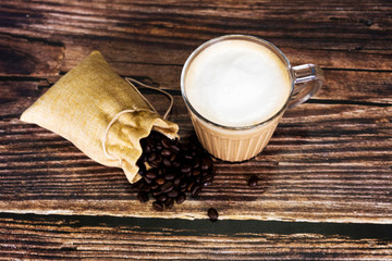 Hot latte coffee on the wooden table surface