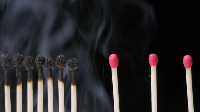 Burnt matches and intact matchsticks with smoke. Social Distancing Concept