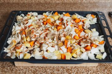 Diced vegetables lie on metal baking sheet