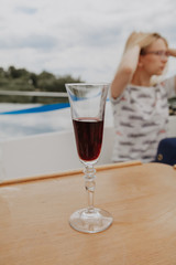 Elegant red wine glass on wooden table