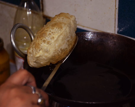 Bengali Luchi Or Indian Poori Taken Out Straight From Frying Pan. Luchi's Or Puri Are Deep Fried Bread Made From Flour