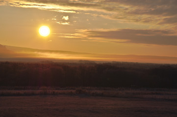 朝の太陽に弱く光る早暁の原野。北海道、日本。