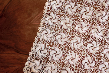 lace hand-knitted. lace tablecloth. Patterns knitted with lace crochet. Lace hand-knitted on wooden table.