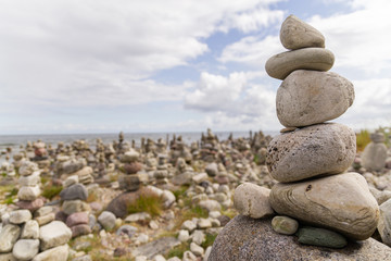 Smooth grey and white stones on each other on the beach
