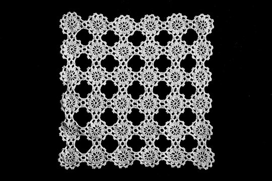 lace hand-knitted. lace tablecloth. Patterns knitted with lace crochet. Lace hand-knitted on wooden table.