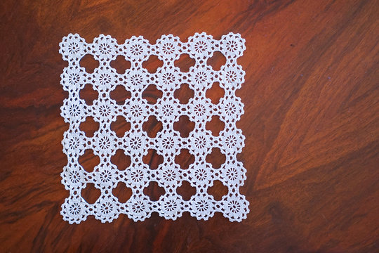 lace hand-knitted. lace tablecloth. Patterns knitted with lace crochet. Lace hand-knitted on wooden table.