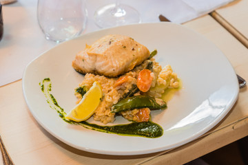 plate of rice with salmon served in a restaurant