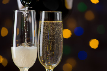 Close-up of champagne pouring in a wine glass