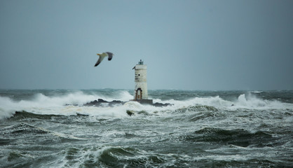The lighthouse of the boat-eater shrouded by the waves of a mistral wind storm