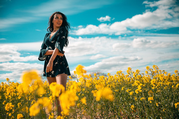 Girl looking at yellow flower field in Denmark