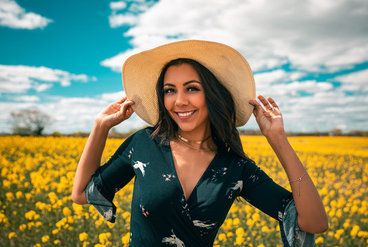 Smiling girl at yellow flower field in Denmark
