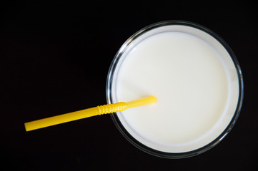Fototapeta na wymiar milk in a glass on a white table