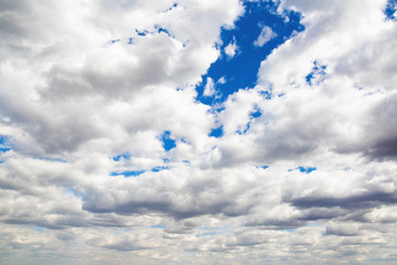 Cumulus thunderclouds on a blue sky in the atmosphere. Background for text and lettering, copy space