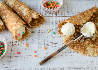 Homemade crispy waffles with ice cream and colorful sprinkles. 